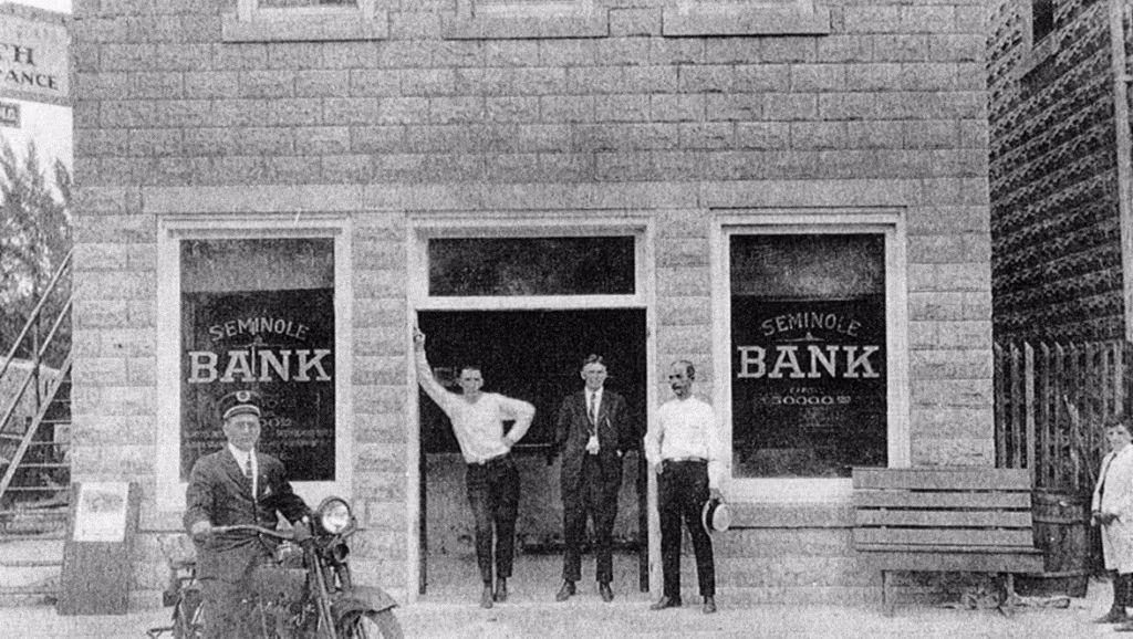 The former 1912 Stuart Bank building served as the Seminole Bank in 1923. John Taylor (2nd from right in a suit) was president of the Seminole Bank.