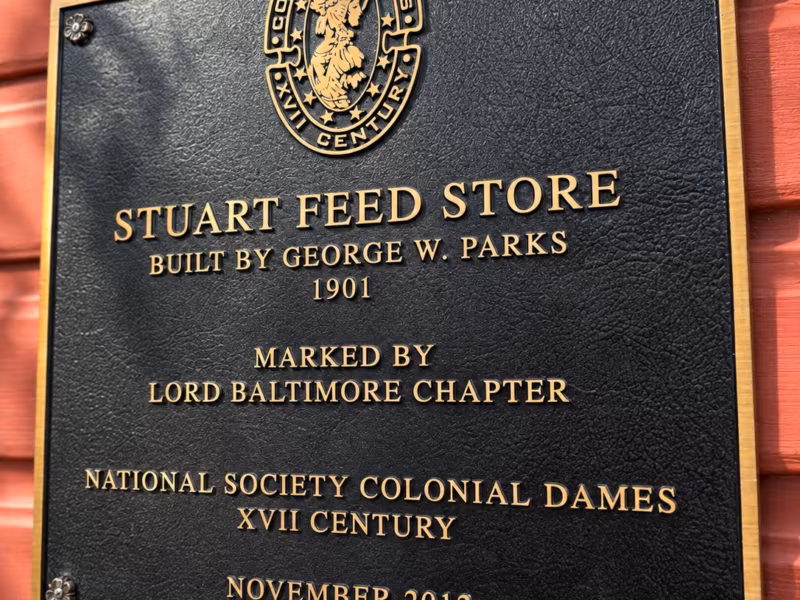 Bronze plaque reading Stuart Feed Store, built by George W. Parks, 1901, marked by the Lord Baltimore Chapter, National Society Colonial Dames XVII Century, November 2012
